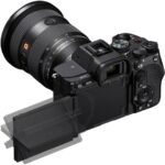 Sony mirrorless camera with adjustable screen and lens, ideal for professional photography.