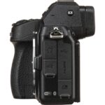 Side view of a digital camera body with various ports and controls.