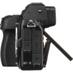 Side view of a mirrorless camera with open screen and ports, available at Camix UK.