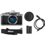 Nikon Z fc mirrorless camera with accessories including battery, strap, and USB cable.