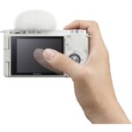 Sony ZV-E10 mirrorless camera with flip screen held in hand, ideal for vlogging and photography.