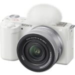 Sony mirrorless camera with lens and microphone, ideal for vlogging and photography.