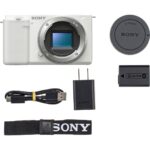 Sony mirrorless camera with accessories including battery, charger, and strap.