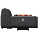Bottom view of a mirrorless camera body with lens mount exposed.