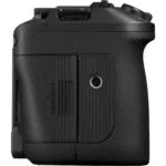 Side view of a black DSLR camera body with textured grip, card slot visible.