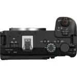 Top view of a Canon mirrorless camera body with control dials and hot shoe.