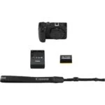 Canon camera body with charger, battery, and strap on white background.