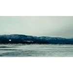 Snowy landscape with mountains and frozen lake, ideal for testing camera equipment.