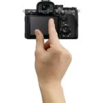 Person using a digital camera with a touchscreen display, available at Camix UK.