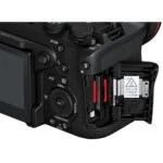 Close-up of a digital camera's dual memory card slots with SD card inserted.