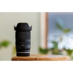Tamron zoom lens on wooden table in camera shop UK