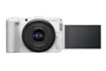 White Canon mirrorless camera with flip-out screen, ideal for vlogging and photography.
