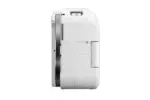 Side view of a white digital camera body with HDMI and USB ports.
