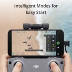 DJI drone controller with smartphone displaying beach scene, highlighting intelligent modes.