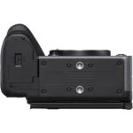 Bottom view of a mirrorless camera body with battery compartment and tripod mount.