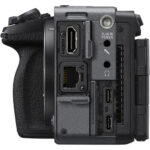 Side view of a professional camera body with various ports and connections.
