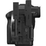Side view of a professional camera body with various ports and connections.