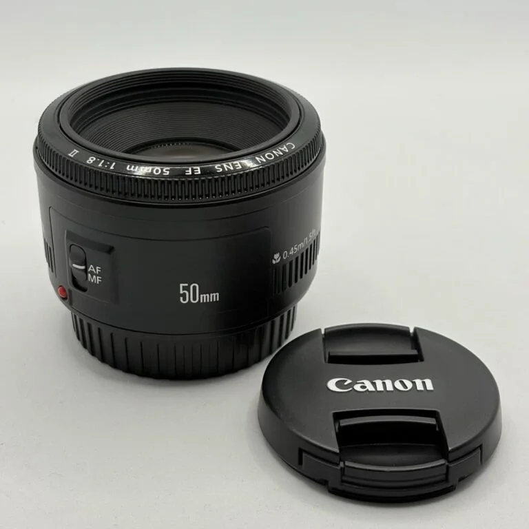 Canon EF 50mm f/1.8 II lens with front and rear caps for DSLR cameras.